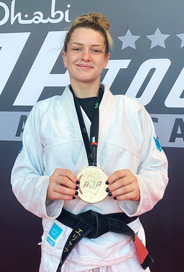 Professor Eliana Carauni holding a medal